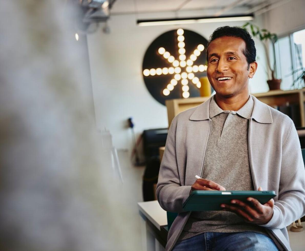 Male smiling with a tablet in his hands