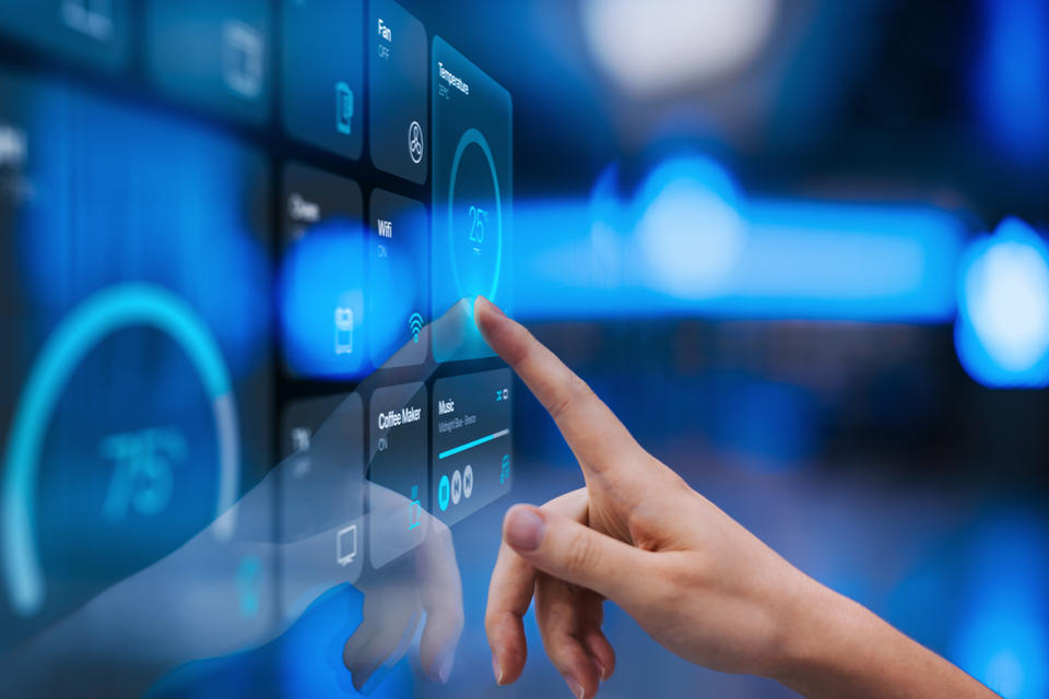 Close up of woman's hand touching  smart home control panel