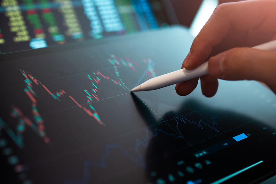 Market Analyze with Digital Monitor focus on tip of finger